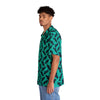 A man wearing Black button Tropical Hawaiian Shirt with fish print side view